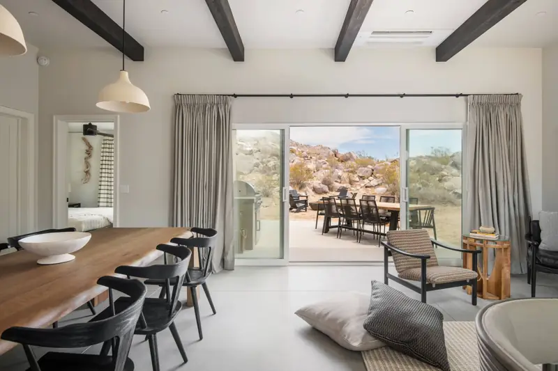 Dining area: The living room has surrounding mountain and boulder views. Wide sliders open up to the backyard brining the outside in. A spacious dining table for 6 is perfect for hosting dinners.