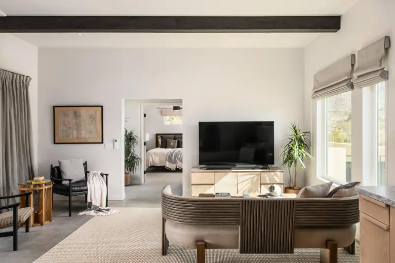 Living room: The living room features designer furniture pieces and a 65" 4K Sony Smart TV with a Sonos sound bar.