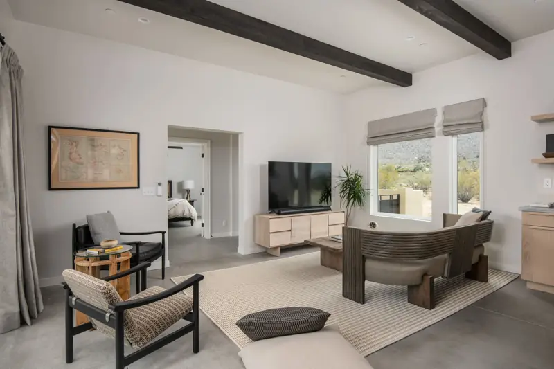 Living room: The living room features designer furniture pieces and a 65" 4K Sony Smart TV with a Sonos sound bar.