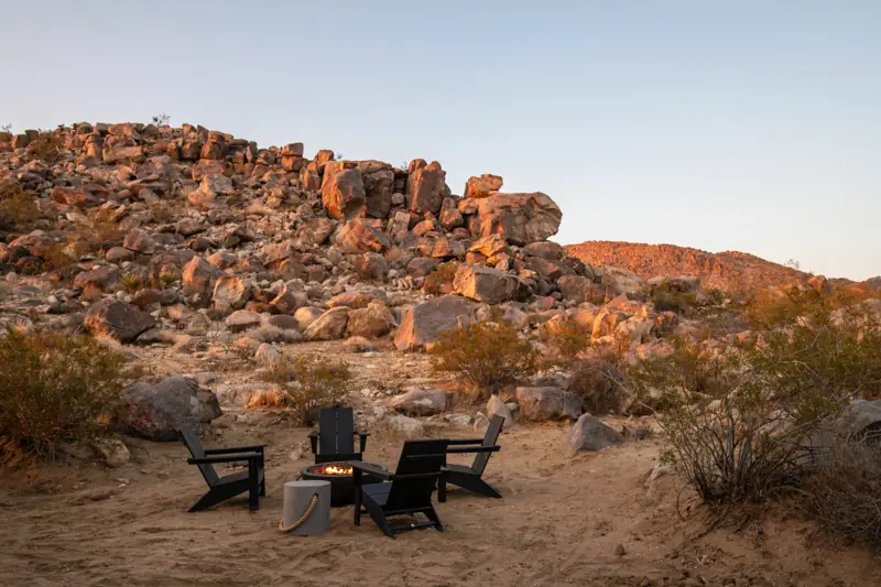 Exterior: A fire pit at the foot of the boulders.